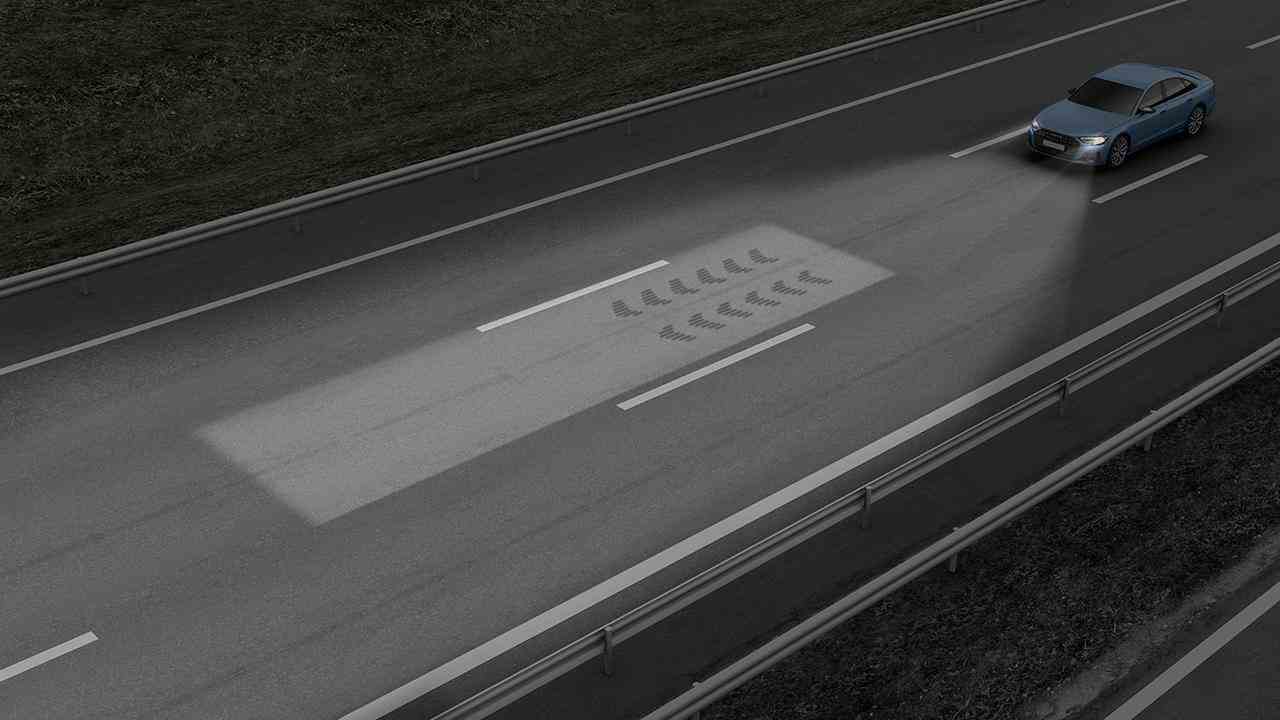 Des projections sur la surface de la route donnent des directions au conducteur.