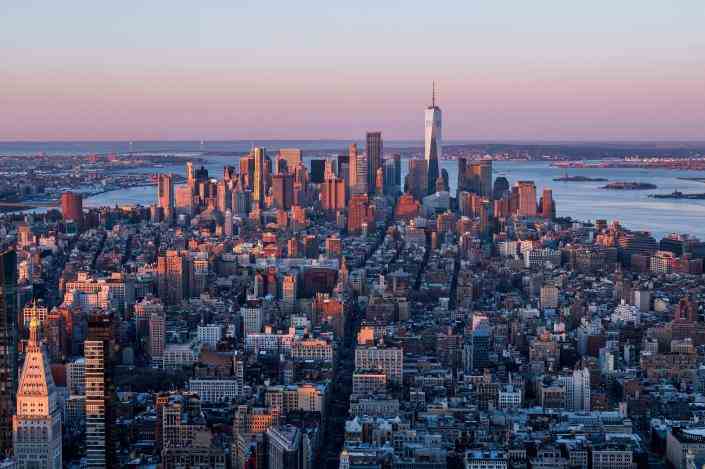 TOPSHOT - La ligne d'horizon de Manhattan est vue au lever du soleil depuis l'observatoire du 86e étage de l'Empire State Building le 3 avril 2021 à New York.  - L'Empire State Building, un gratte-ciel Art déco de 102 étages dans le centre de Manhattan, a ouvert ses portes pendant la Grande Dépression le 1er mai 1931.  / Crédit : ANGELA WEISS/AFP via Getty Images
