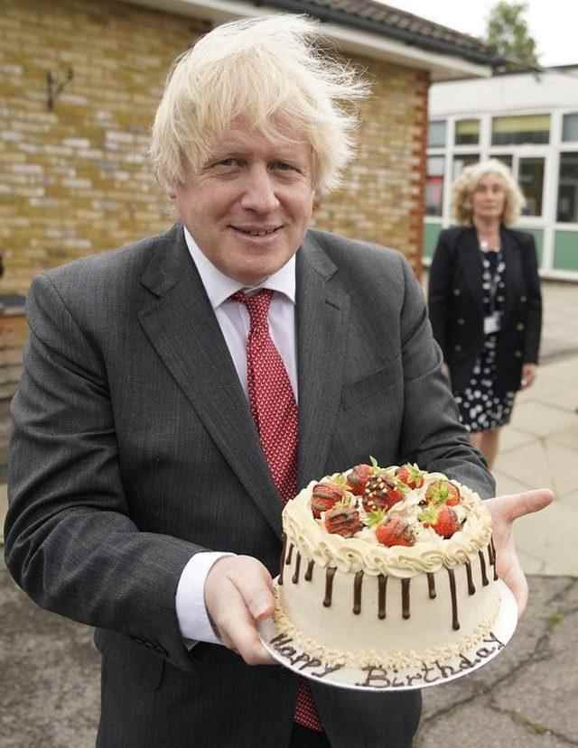 Boris Johnson holding his birthday cake