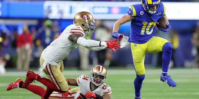 Cooper Kupp (10) of the Los Angeles Rams tackles San Francisco 49ers' Jaquiski Tartt (left) and K'Waun Williams (24) during the second half of their NFC Championship NFL football game on Sunday, January 30, 2022 in Inglewood. past. Calif.