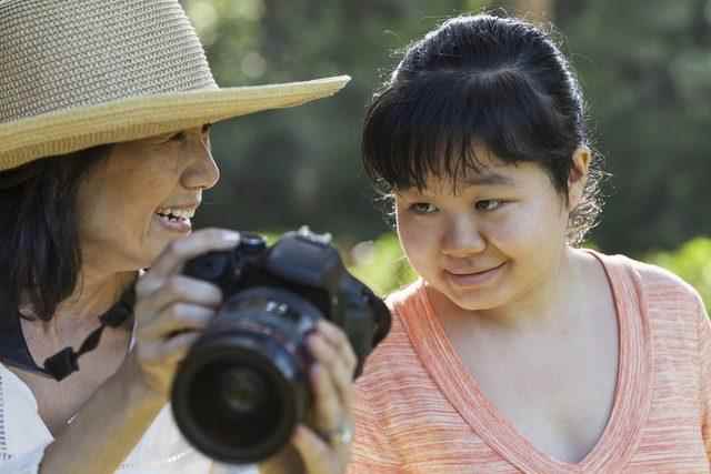 mother showing photo to woman with autism