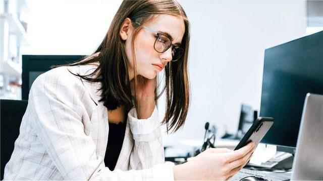 Young female employee looking at the screen