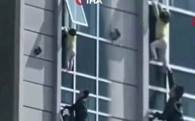 Scary moments 3 year old boy hangs in 8th floor window