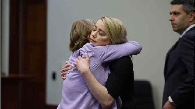 Amber Heard embraces her lawyer after hearing jury verdict