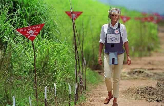Diana, Princess of Wales wearing protective body armor and a visor visits a landmine minefield being cleared by the charity Halo in Huambo