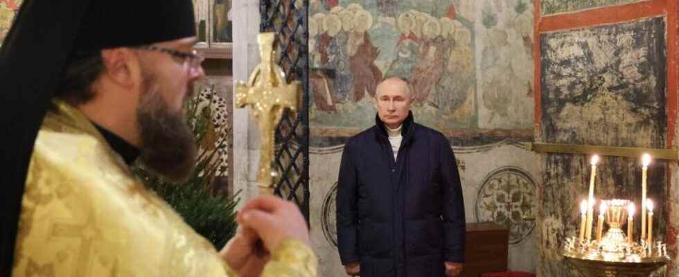 Vladimir Putin attends an Orthodox Christmas service alone in a
