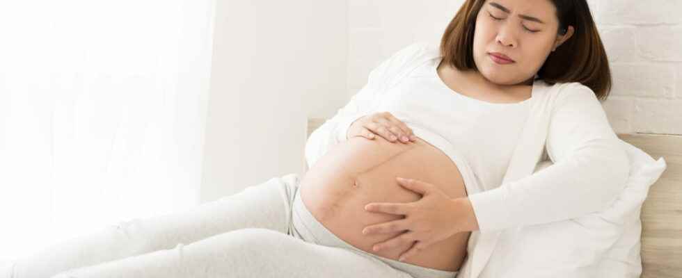 Hard belly pregnancy in which month what causes